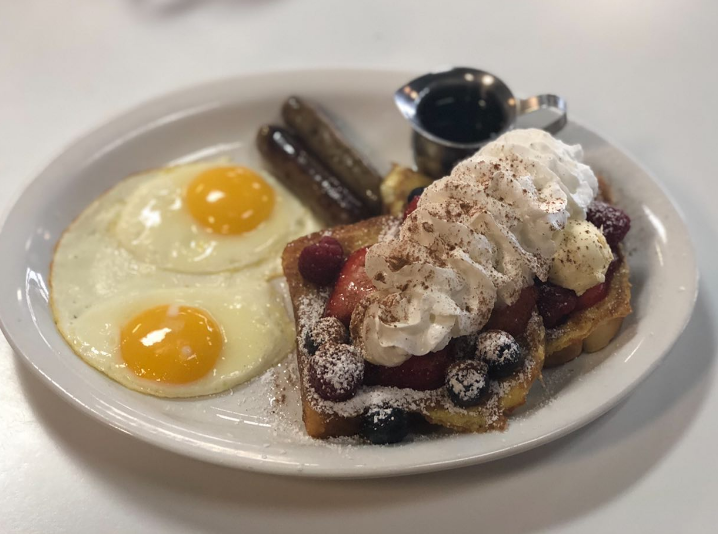 Berry French toast with two eggs and sausage