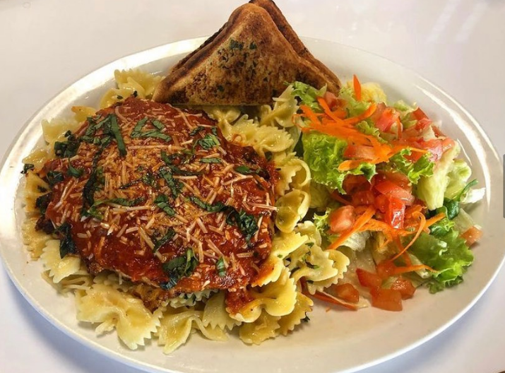 Chicken parmesan over bowtie pasta with garlic toast and salad
